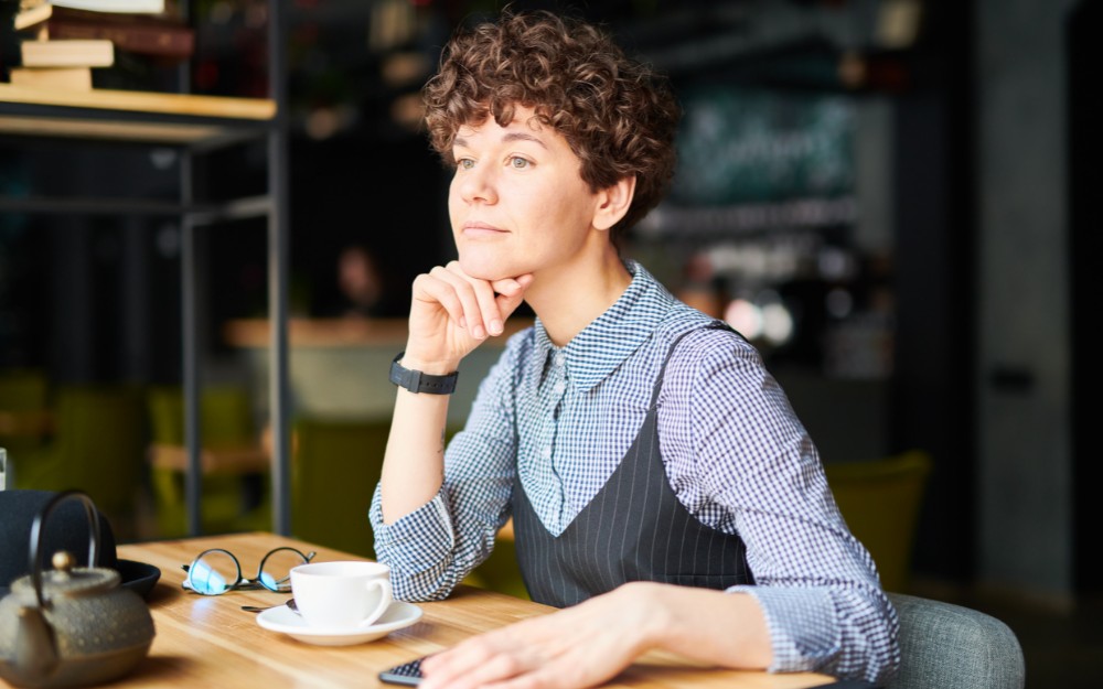 Woman in a coffee shop, Thinking of Buying a Café in NSW